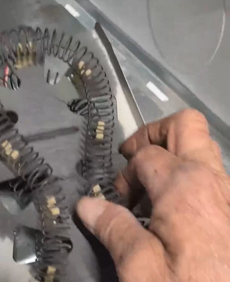 Owner Mickey checking the failed heating element inside a Whirlpool electric dryer during an in-home repair in Leon Valley, TX